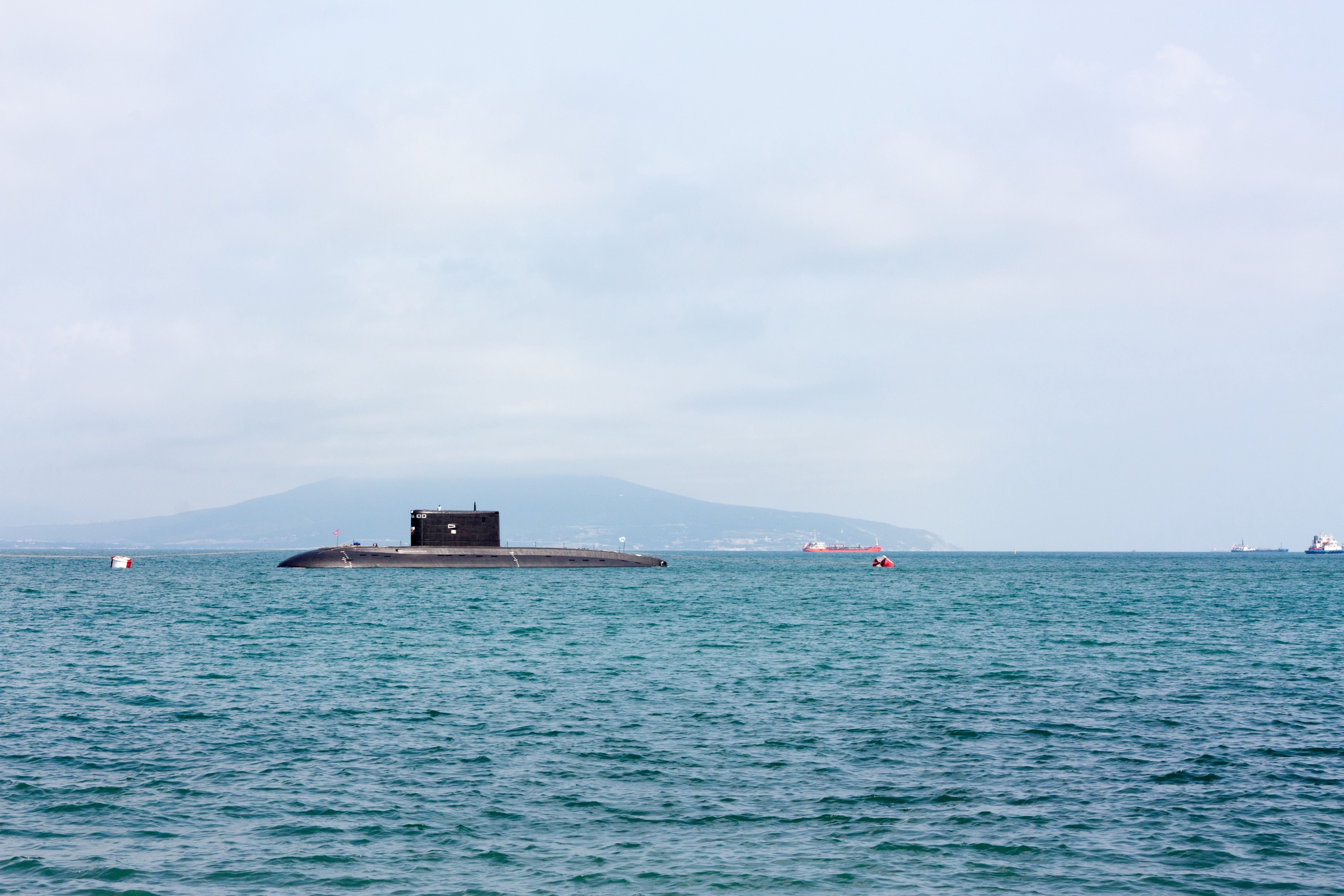 a picture of a surface submarine in the distance